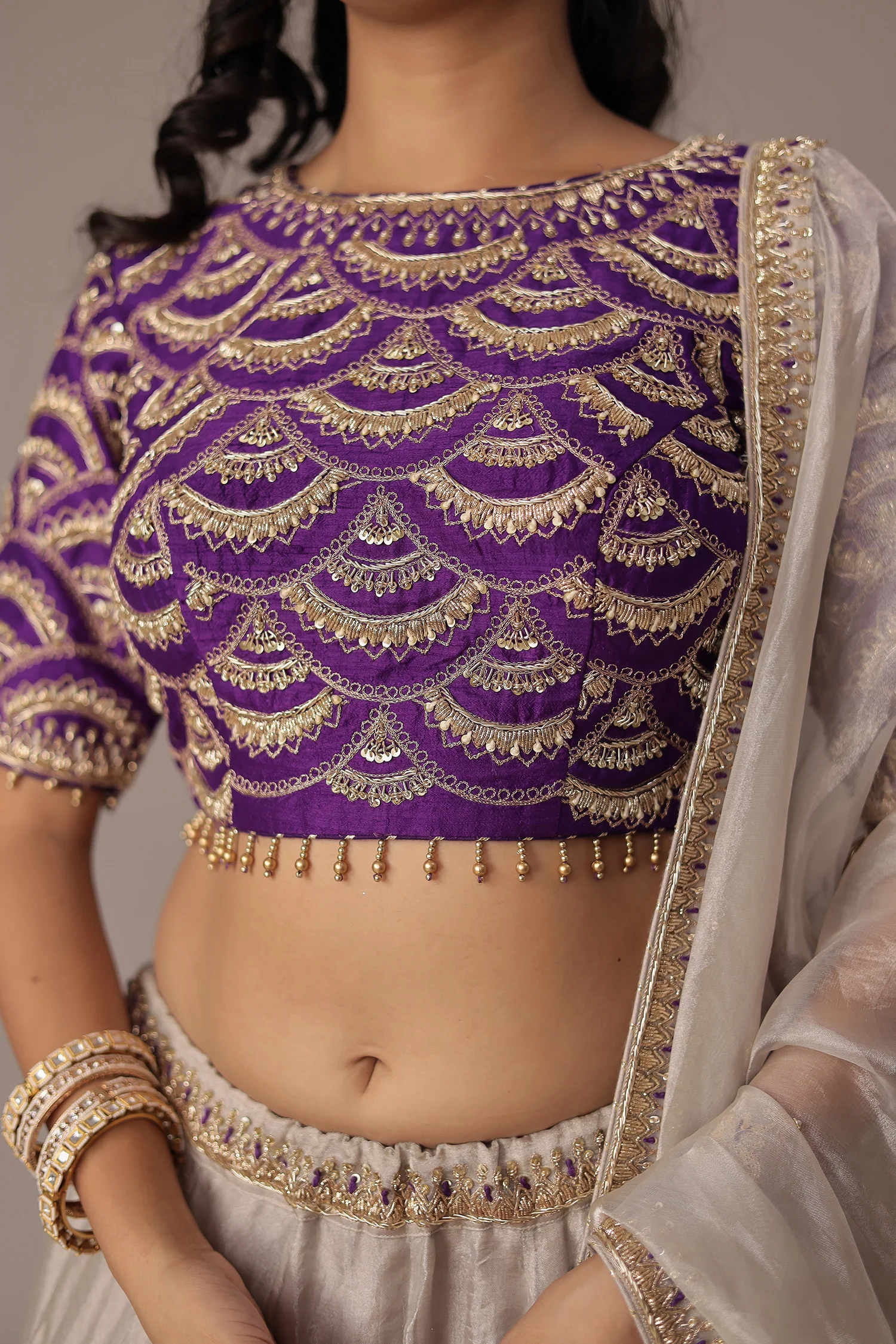 Ivory Shimmer Tissue Lehenga with Intricate Aari, Pearl, Thread & Zardozi Embroidery Paired with a Royal Purple Blouse - Image 5